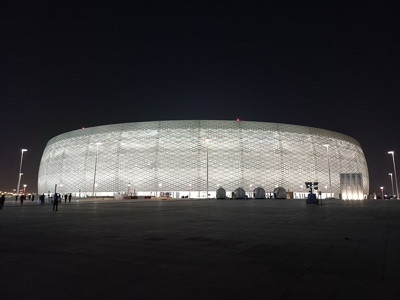 al thumama stadium at night lit up